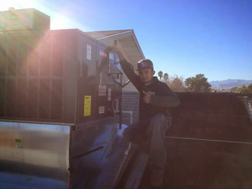 HVAC technician performing HVAC Inspection on a rooftop unit in Powdersville